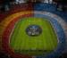Estadio con gradas de España y Argentina y el diseño Zasca in Games con Promesas del Fútbol sobre el campo.